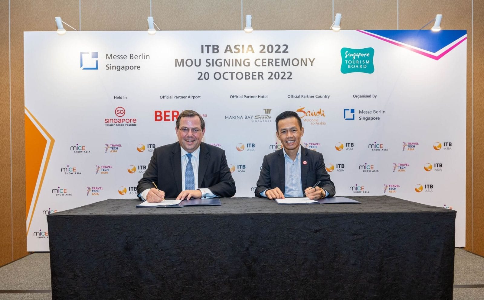 Official signing ceremony at ITB Asia 2022 in Singapore, showcasing partnership agreements for the travel industry.