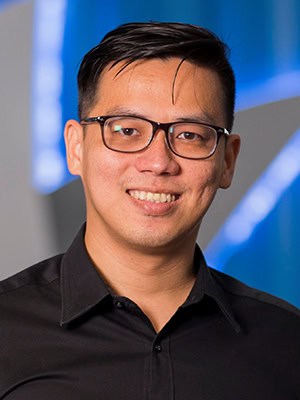 Attendee smiling at the ITB Asia 2026 event in Singapore, a major travel industry trade show.