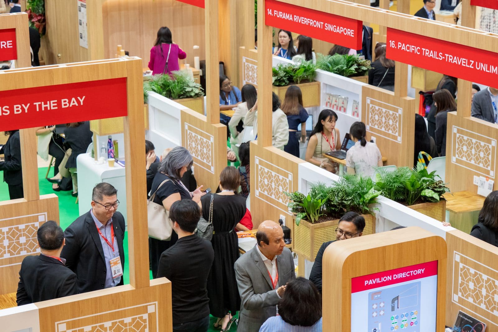 Exhibitors and visitors engaging at various booths during ITB Asia 2026 in Singapore.
