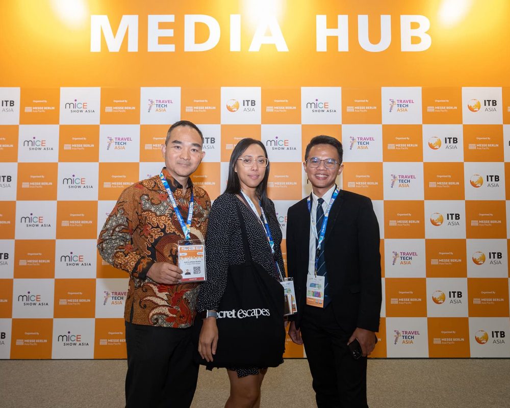 People attending ITB Asia 2026 at Media Hub with event badges and background logo grid.