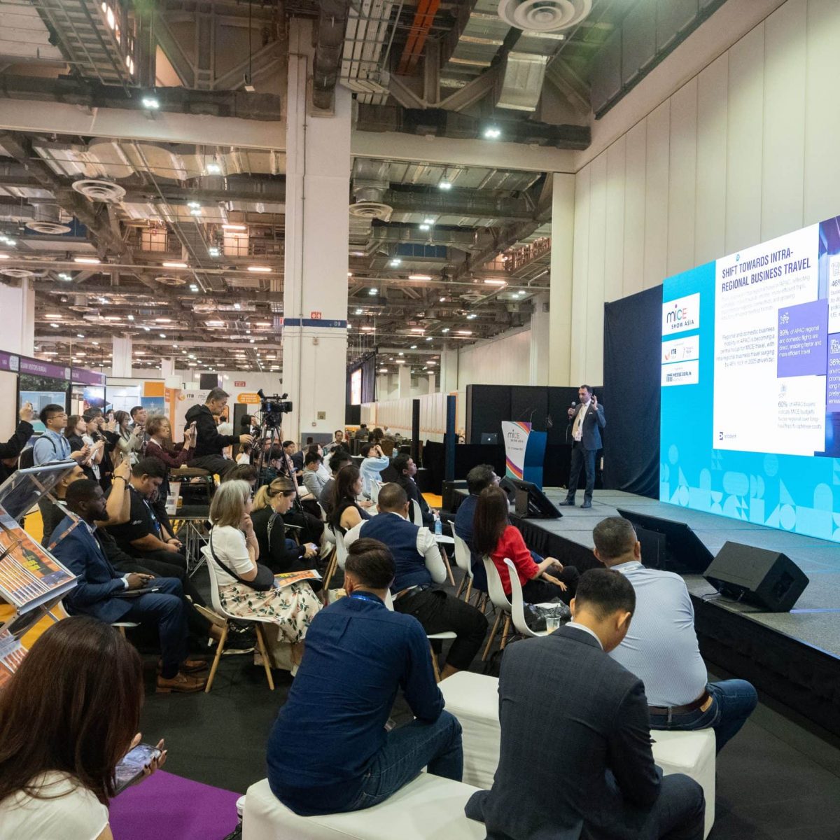 Vibrant conference at ITB Asia 2026 travel trade show in Singapore, with attendees engaging in insightful presentations.