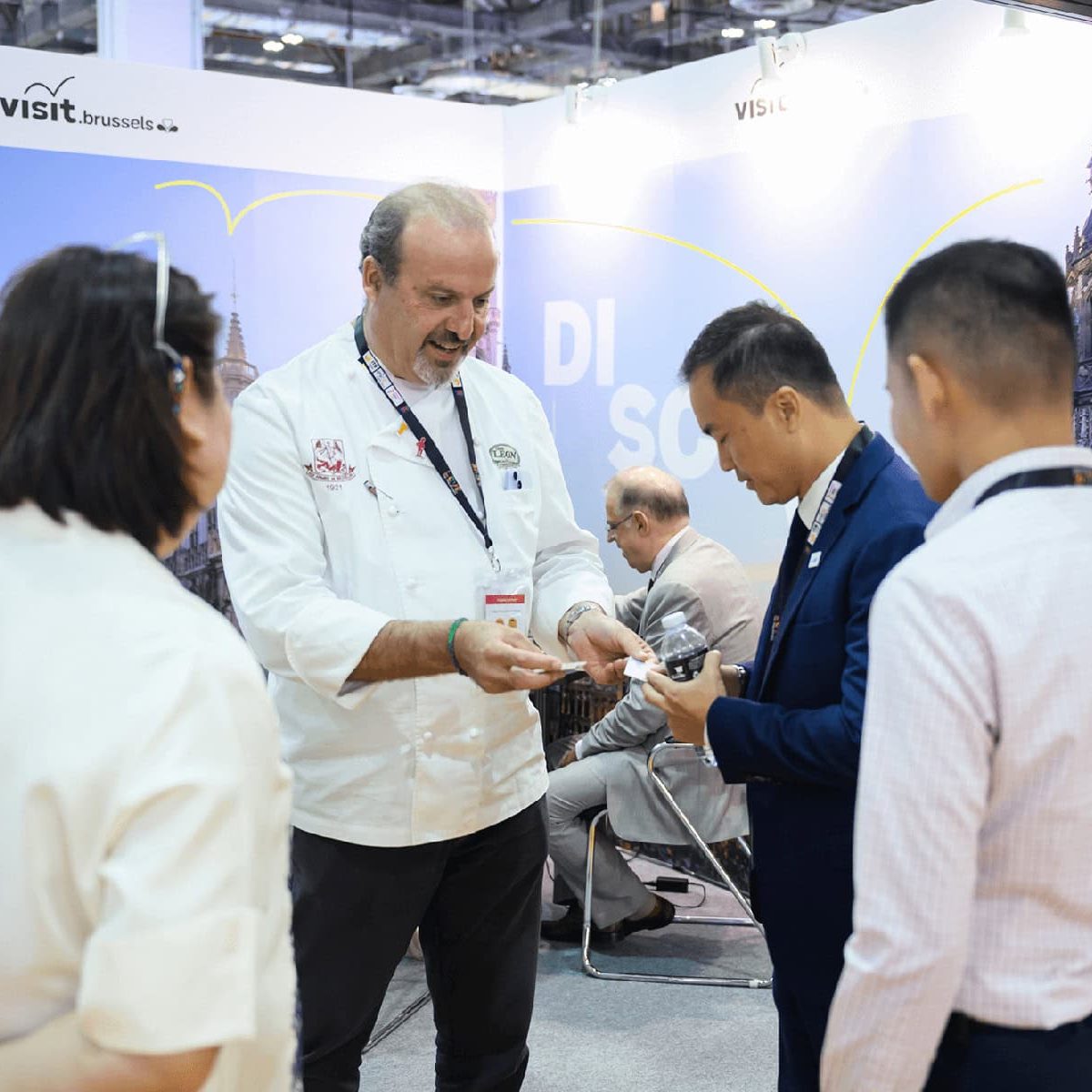Diverse attendees engaging at the ITB Asia 2026 travel trade show booth in Singapore.