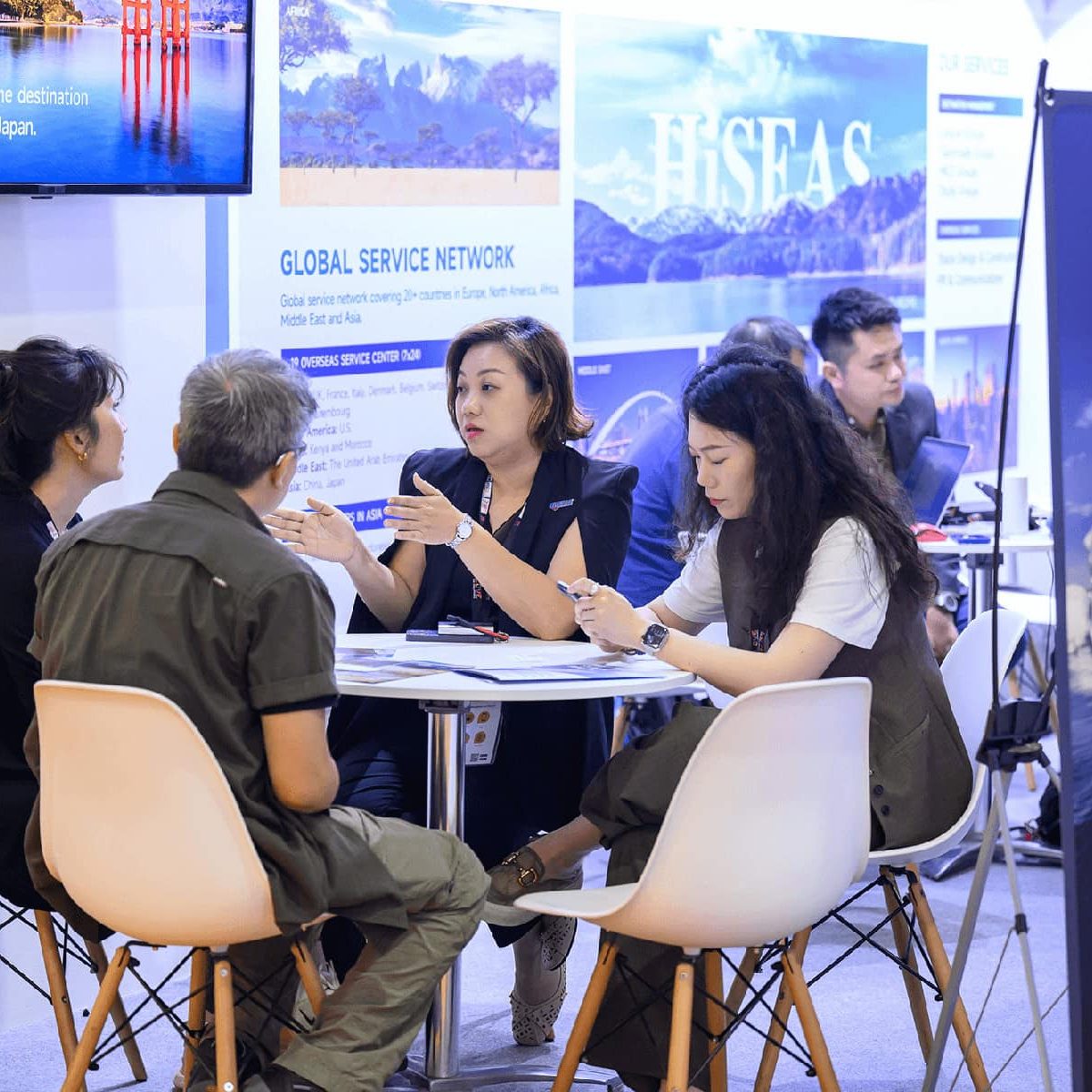 Diverse travel representatives discussing at ITB Asia 2026 in Singapore, showcasing global tourism partnerships and services.