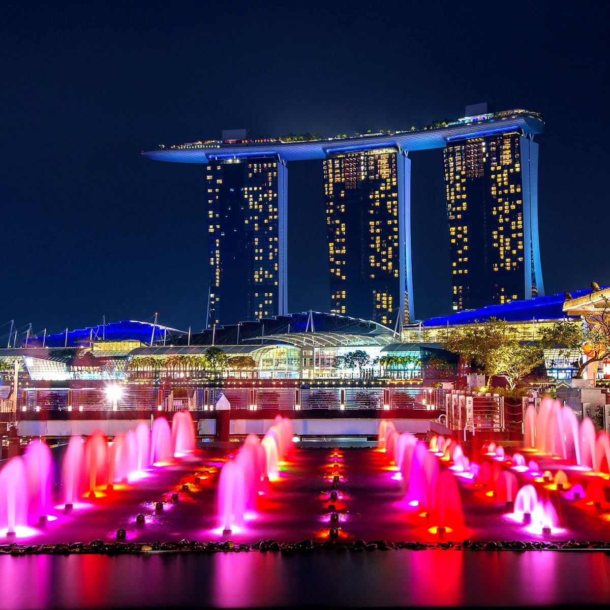 Night view of Marina Bay Sands with colorful fountains in Singapore.
